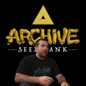 CEO and Founder Fletcher Watson wearing an Archive Seed Bank shirt in front of the Archive Seed Bank logo, with "Not For Sale" branding.