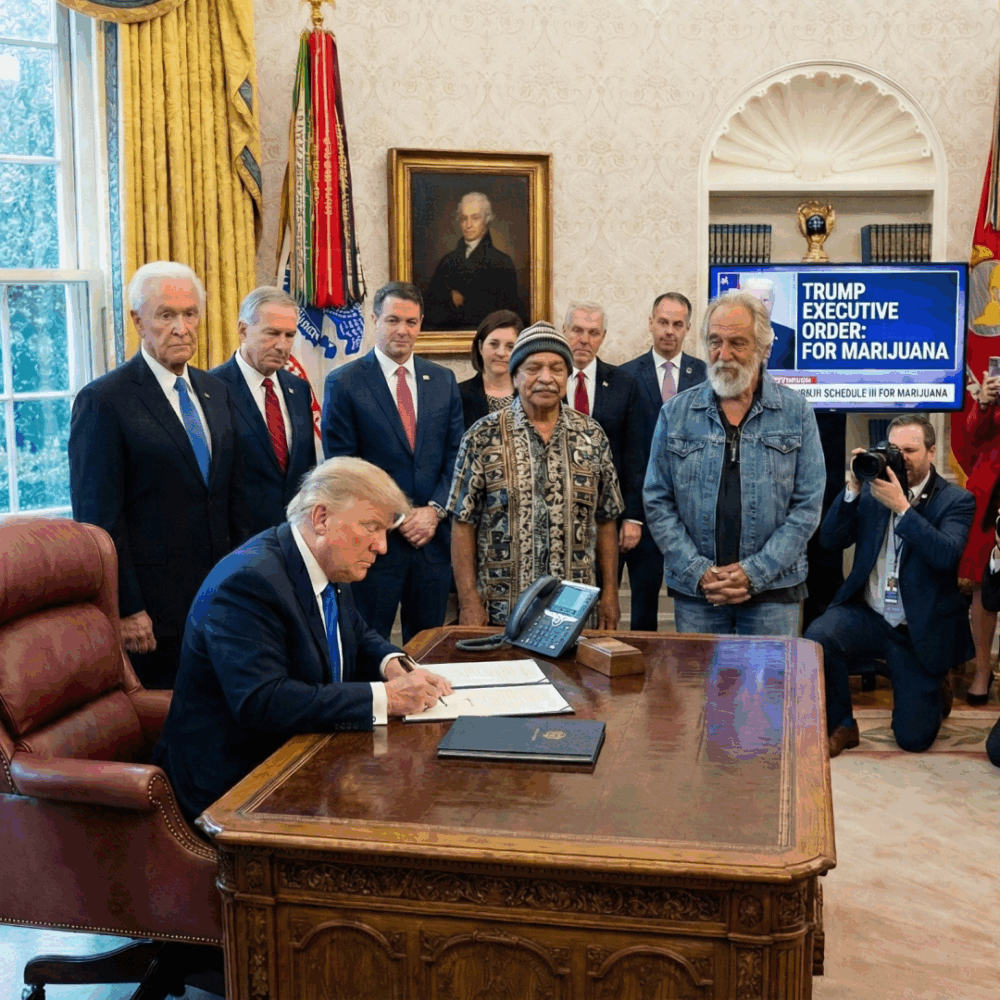 President signs an executive order related to marijuana policy while officials and media look on in the Oval Office.